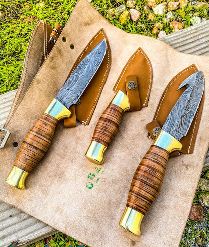 Wilderness Trio: 3-Piece Hunting Knives Set with Damascus Steel Blades, Stacked Leather Handles, Brass Guards, and Leather Roll